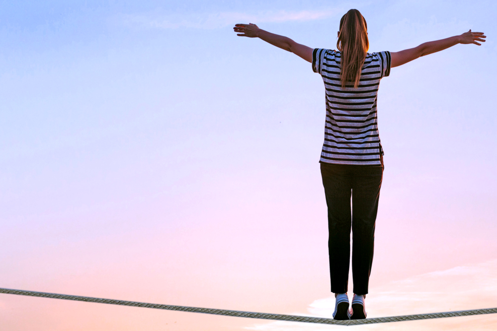 Woman stands with arms outstretched